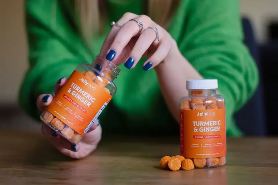 A hand pointing to the other ingredients section on a supplement label