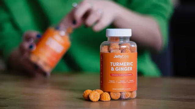 A pet owner comparing a human fish oil bottle against a dog joint chew jar on a kitchen counter