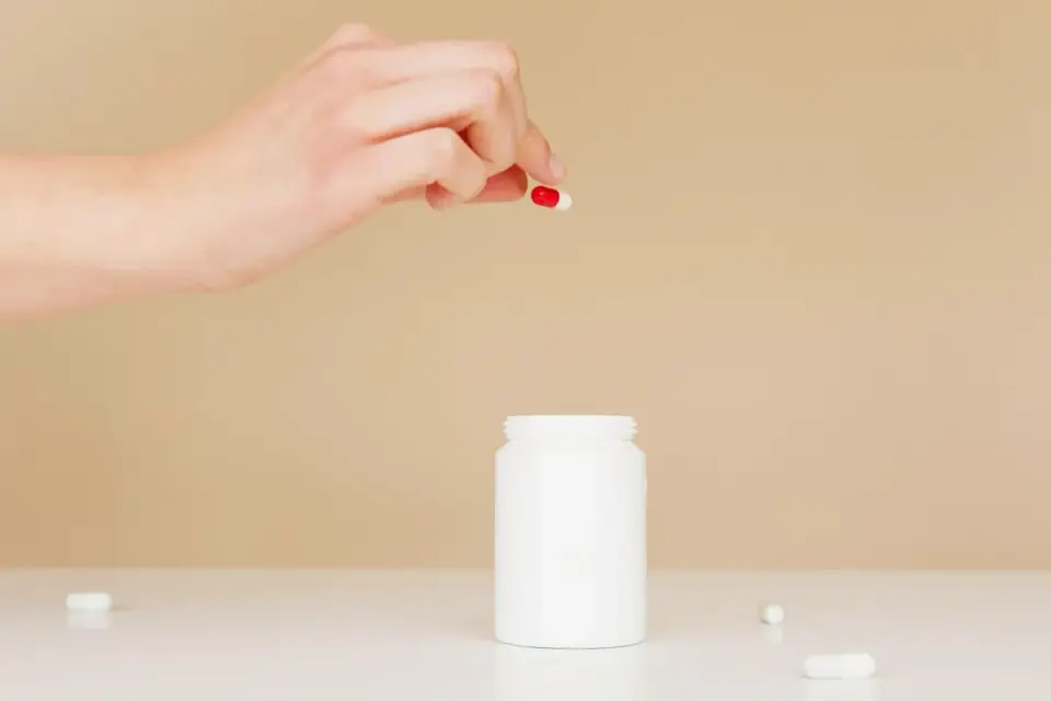 A veterinarian examining a supplement bottle label closely
