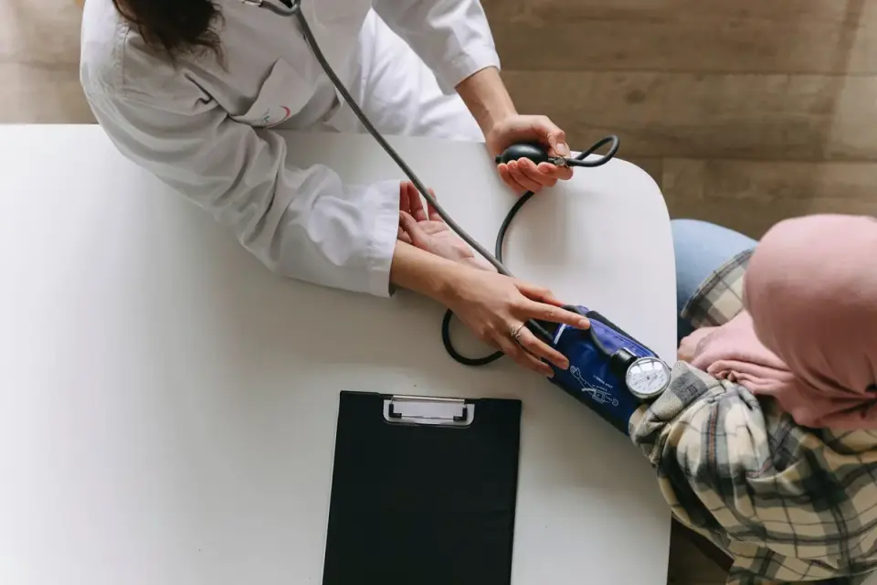 A veterinarian gently examining a dog&#x27;s hind leg on an exam table
