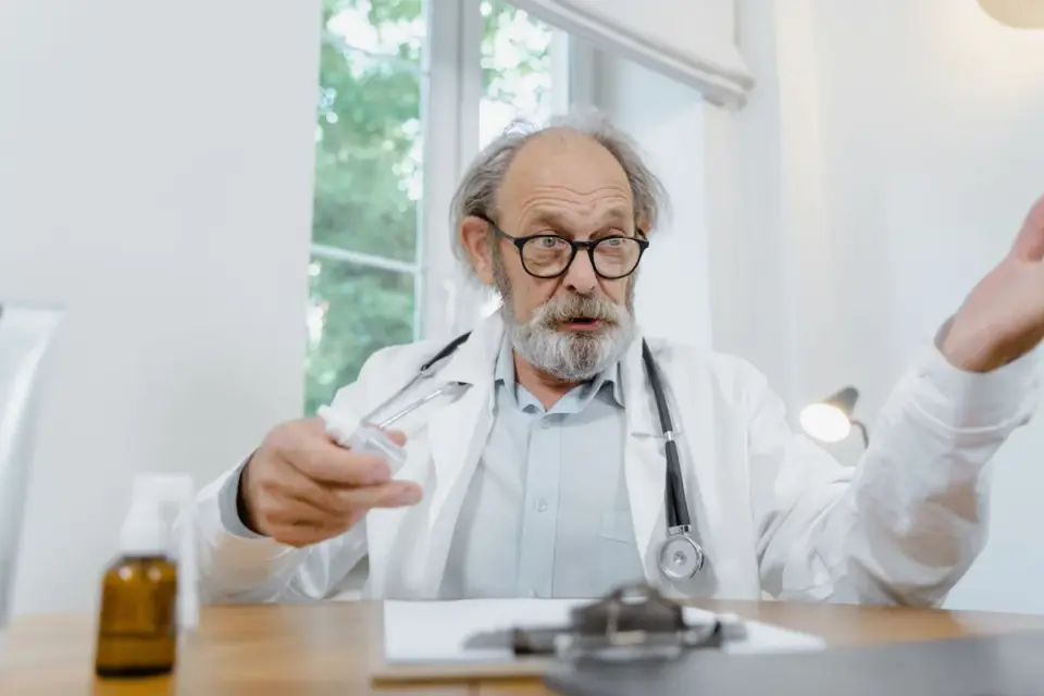 A veterinarian reading a supplement label alongside a dog on an exam table