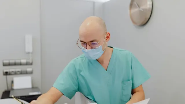 A veterinarian reading the ingredient panel on a dog supplement bottle