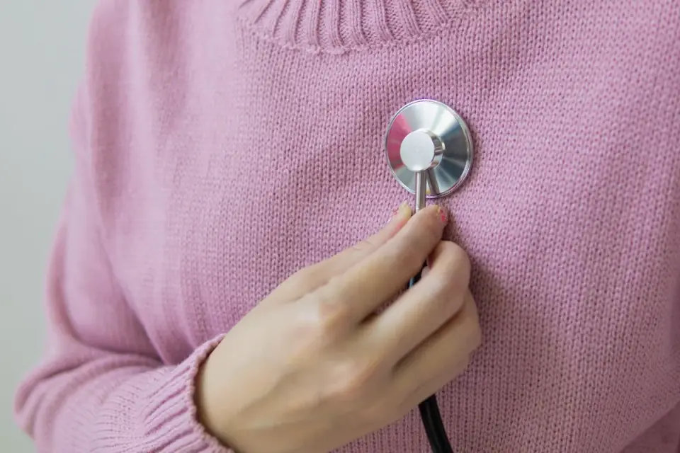 A veterinarian using a stethoscope to listen to a dog&#x27;s heart