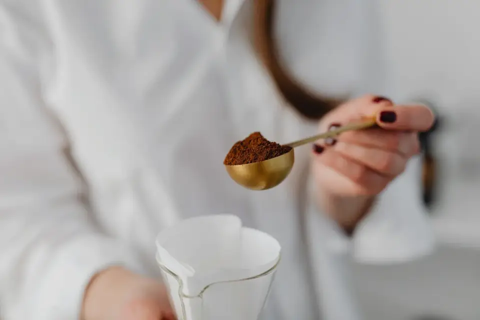 Close-up of joint supplement powder being scooped with a measuring spoon