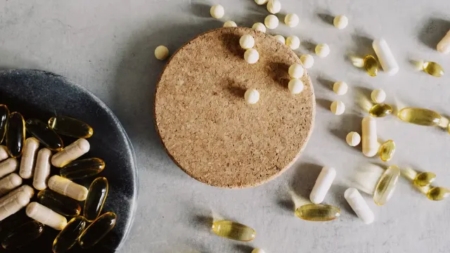 Two dog joint supplement bags open on a kitchen counter with a magnifying glass over the supplement facts panel